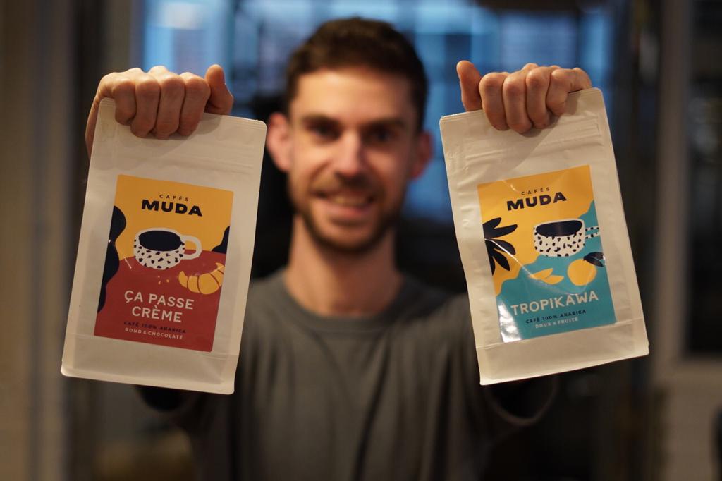 Member proudly presenting their first bags of coffee